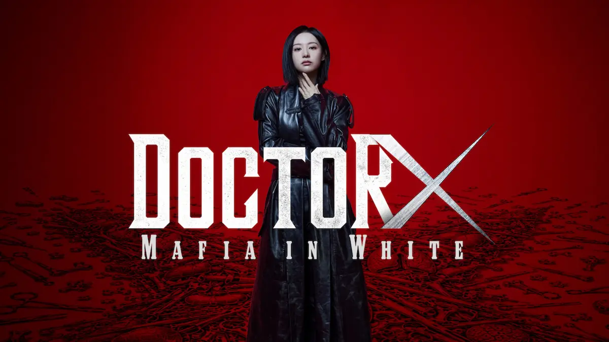 A woman in a black leather trench coat standing in front of a red background