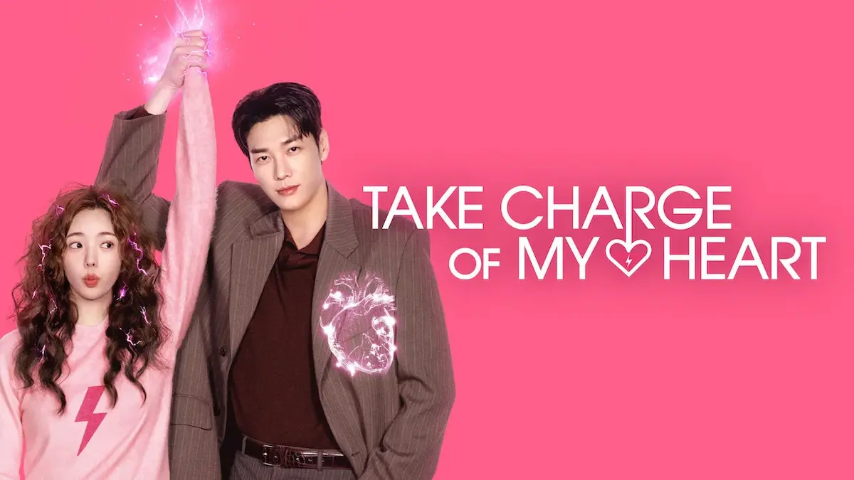 A woman in a pink sweater and a man in a brown suit holding hands raised against a pink background